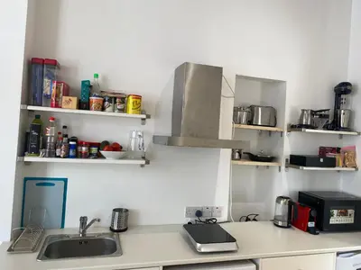 a kitchen with a counter with a sink and shelves at ToHaniMou - Kamara Medium Studio in Nicosia