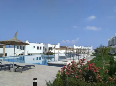 a resort with a swimming pool with chairs and umbrellas at 3 bedrooms villa with own pool!