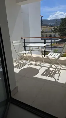 a table and chairs on a balcony with a view at 3 bedrooms villa with own pool!