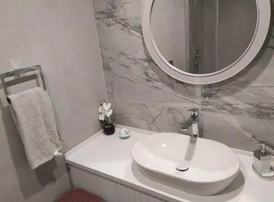 a bathroom with a white sink and a mirror at 3 bedrooms villa with own pool!