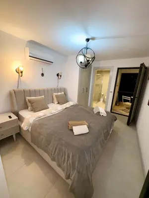 a large bedroom with a large bed with a light at 3 bedrooms villa with own pool!
