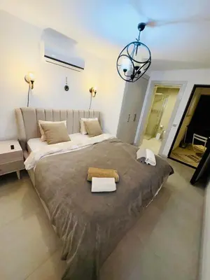 a bedroom with a large bed with a chandelier at 3 bedrooms villa with own pool!