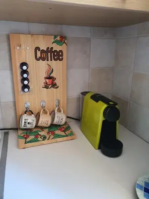 a toy kitchen with a coffee machine and a toaster at Lovely ground floor apartment with BBQ in Aglantzia