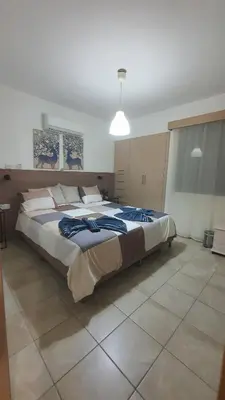 a large bedroom with a large bed in it at Lovely ground floor apartment with BBQ in Aglantzia