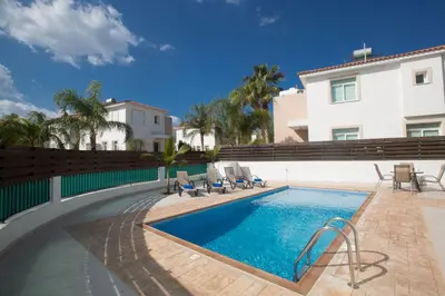 a swimming pool in front of a building at Protaras Holiday Villa Me25 in Protaras