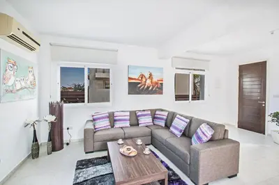 a living room with a couch and a table at Protaras Holiday Villa Me25 in Protaras