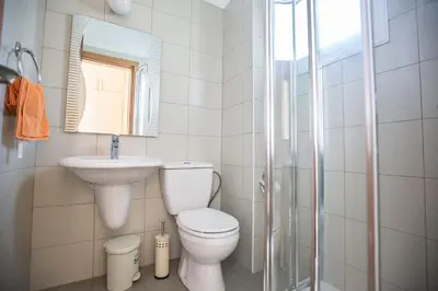 a bathroom with a toilet and a sink and a shower at Protaras Holiday Villa Me25 in Protaras
