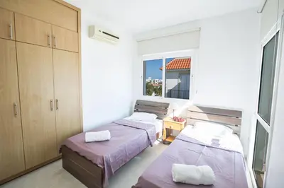 two beds in a room with a window at Protaras Holiday Villa Me25 in Protaras