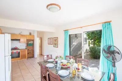 a kitchen and dining room with a table and chairs at Ayia Napa Holiday Villa At26 in Ayia Napa