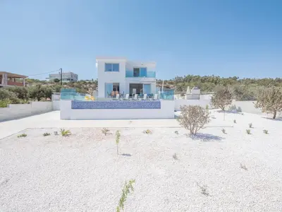 a house on the beach with a lot of sand at Villa Clea,stunning 4bdr Protaras Villa, Seaviews in Protaras