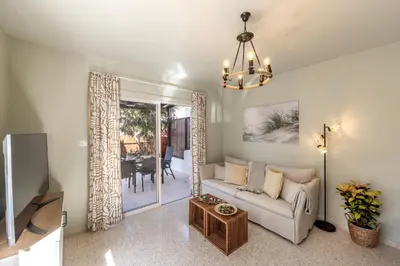 a living room with a couch and a tv at Laranca Oneiro Seaside Villa in Pervolia
