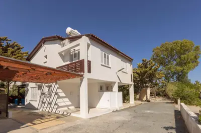 a white house with a staircase on the side at Laranca Oneiro Seaside Villa in Pervolia