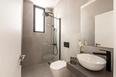 a bathroom with a sink and a toilet and a shower at Protaras Aqua Pearl Villa 9 in Protaras