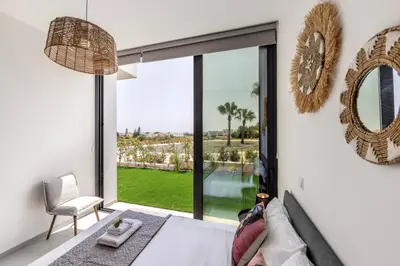 a bedroom with a bed and a large window at Protaras Aqua Pearl Villa 9 in Protaras