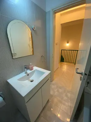 a bathroom with a white sink and a mirror at Sunny 2BR Home in Paralimni Near Beaches,Protaras! in Paralimni