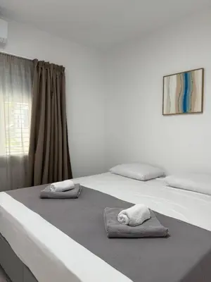 two towels are sitting on top of two beds at Ayia Napa 2BR - Prime Location in Ayia Napa