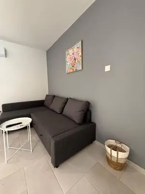 a living room with a couch and a table at Ayia Napa 2BR - Prime Location in Ayia Napa