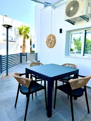 a blue table and chairs on a patio at Ayia Napa 2BR - Prime Location in Ayia Napa