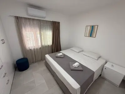 a bedroom with a bed with two towels on it at Ayia Napa 2BR - Prime Location in Ayia Napa