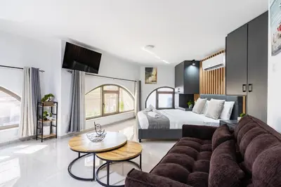 a living room with a couch and a bed at Sweet Bonanza Studio in Larnaka