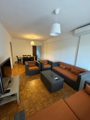 a living room with a couch and a television at River Court, Flat 8 in Nicosia