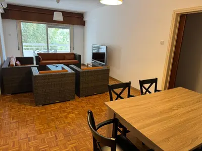 a living room with a couch and a table at River Court, Flat 8 in Nicosia
