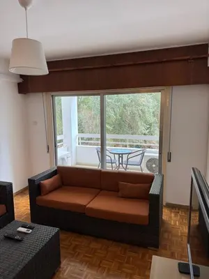 a living room with a couch and a table at River Court, Flat 8 in Nicosia