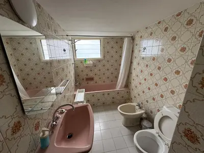 a bathroom with a pink sink and a toilet and a tub at River Court, Flat 8 in Nicosia