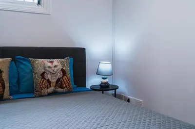 a bedroom with a bed with a cat pillow on it at Central & Cozy Larnaca Suite in Larnaka