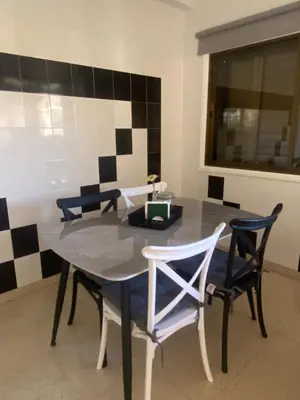 a dining room with a table and two chairs at Sweet Home Apartment 3-Bedrooms in Larnaka