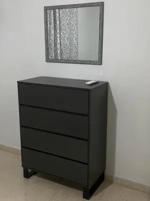 a black dresser with a mirror on top of it at Sweet Home Apartment 3-Bedrooms in Larnaka