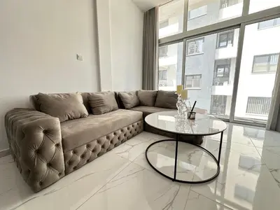 a living room with a couch and a table at Home For You - Holiday Apt Larnaca in Larnaka