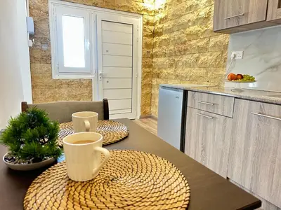 a kitchen with a table with two cups on it at Home For You - Holiday Apt Larnaca in Larnaka