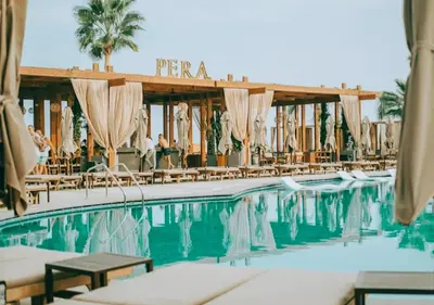 a pool at a resort with chairs and umbrellas at Grand Sapphire Luxury Residence in Iskele