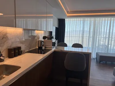 a kitchen with a sink and a counter with a chair at Grand Sapphire Luxury Residence in Iskele