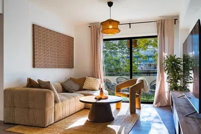 a living room with a couch and a table at City Centre Modern Boho Stay in Nicosia