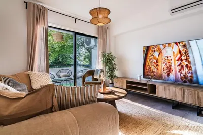 a living room with a couch and a tv at City Centre Modern Boho Stay in Nicosia