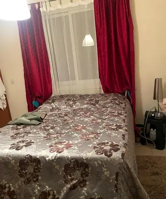 a bedroom with a bed with red curtains at Makenzy 2 Bedrooms Apartment for rent in Larnaka