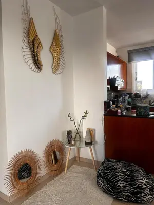 a room with a table and some feathers on the wall at Makenzy 2 Bedrooms Apartment for rent in Larnaka