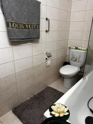 a bathroom with a toilet and a bath tub at Makenzy 2 Bedrooms Apartment for rent in Larnaka