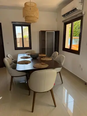 a dining room with a table and chairs at Dene Hollow kapparis in Paralimni