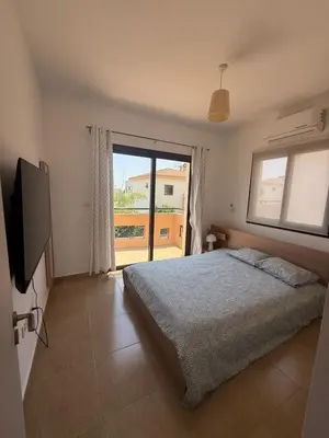 a bedroom with a bed and a large window at Dene Hollow kapparis in Paralimni