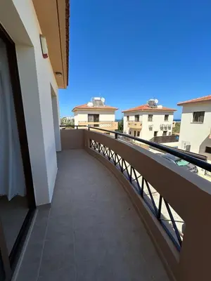 a balcony with a view of a building at Dene Hollow kapparis in Paralimni