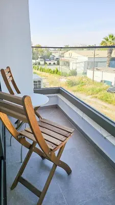 a chair sitting on top of a balcony with a view at Beachside Breeze Apartment in Larnaka