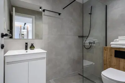 a bathroom with a shower and a sink and a toilet at 26 Suites in Limassol