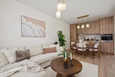 a living room with a white couch and a table at The Serene Suite in Larnaka