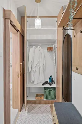a kitchen with a closet with white clothes at The Serene Suite in Larnaka