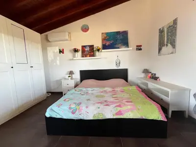 a bedroom with a bed and a dresser in it at Digital Detox with 100 Animals Nature Stay in Dasaki Achnas