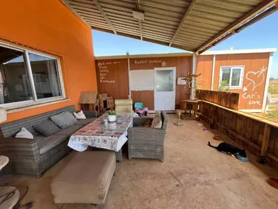 a living room with a couch and a table at Digital Detox with 100 Animals Nature Stay in Dasaki Achnas