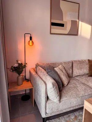 a living room with a couch and a lamp at Cozy & Stylish 1Bedroom Apartment in Limassol